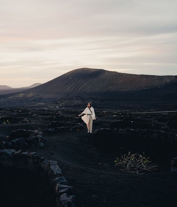 Woman meditating peacefully in a calm, dark environment.